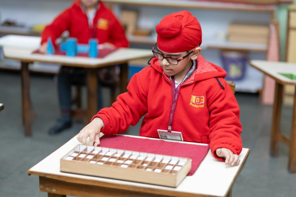 A child focused on educational activity in a Montessori classroom. Bright learning environment.