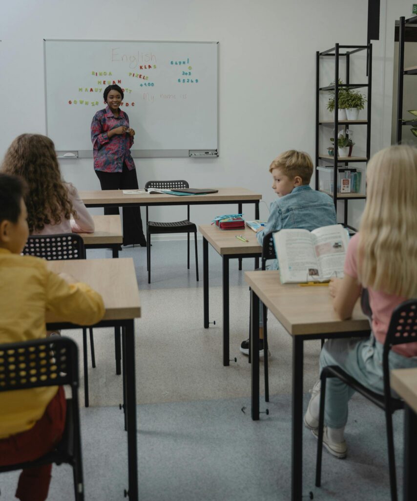 Classroom scene with a diverse group of students learning with a teacher.